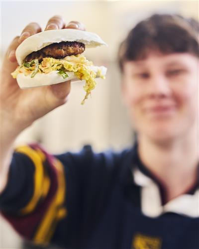 Students holding a burger